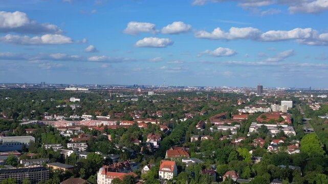 berlin zehlendorf suburb showing buildings and s bahn train station on a sunny summer day. Fantastic aerial view flight descending drone