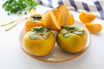 Korean persimmon pile in ceramic plate on white background
