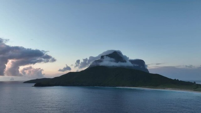 Aerial footage of Lord Howe island early morning over the water looking towards Mount Gower