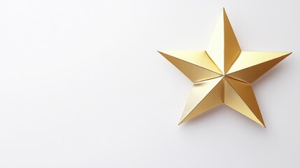 Obraz premium An intricate golden star made of folded paper sits elegantly on a smooth white surface, capturing light beautifully