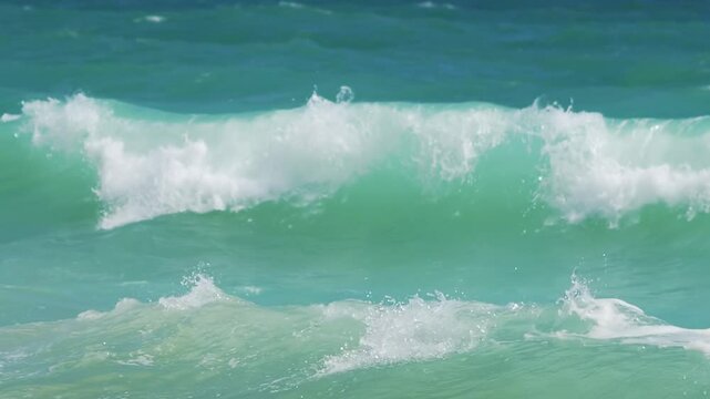 Waves gently rolling onto the sandy beach in slow motion in slow motion 300fps