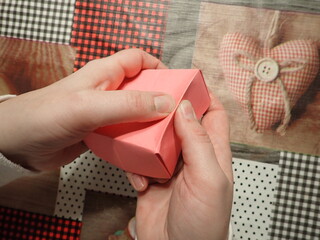 Origami jewelry box made of colored papers. Step 10 from 12