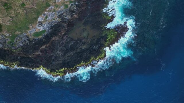 Aerial footage of Lord Howe island above one of its coastal rock shelves looking down