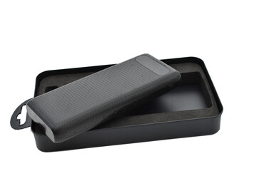 The black power bank lies on top of the packaging box.