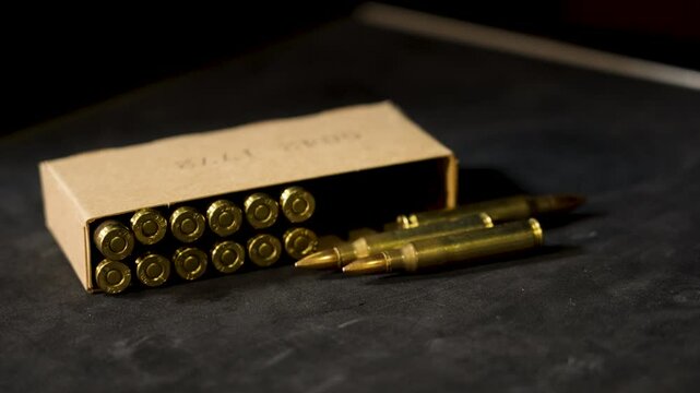 Loose rounds of 5.56 near their box. for civilian use.