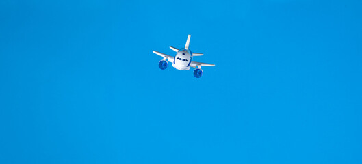 toy airplane flies in cotton wool clouds