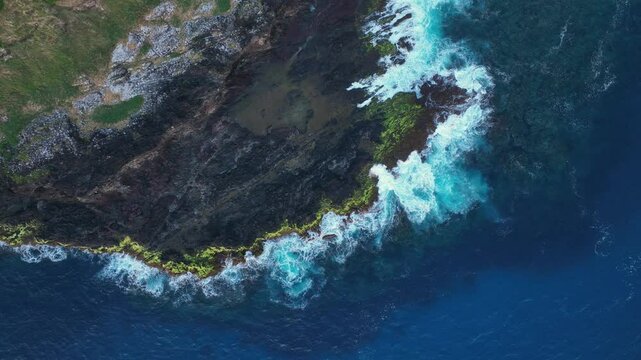 Aerial footage of Lord Howe island above one of its coastal rock shelves looking down
