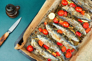 Whole roasted fish with lemon slices and herbs.