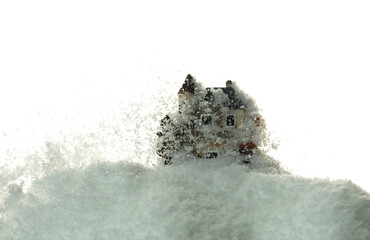 Snow fall cover house over white background isolated. Winter snow storm falling on house like avalanche from climate change extreme weather disaster