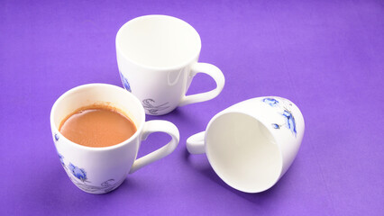 Top view of colorful working table have Headphones,mobile phone and cup of tea on color blue, Yellow and pink background for create idea for business or design. Relax time listen song (flat lay).