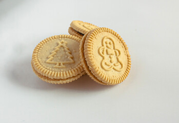 Round cookies with including Christmas symbols such as trees, snowmen and other holiday characters. Vanilla or butter sandwich cookies.