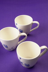 Top view of colorful working table have Headphones,mobile phone and cup of tea on color blue, Yellow and pink background for create idea for business or design. Relax time listen song (flat lay).