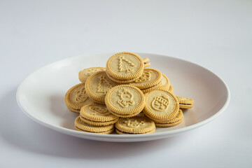 round cookies with various designs on them, including Christmas themed symbols like trees, snowmen, and other festive characters. vanilla or butter flavored sandwich cookies.