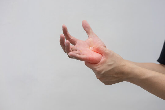 close up young man massage on hand palm after hard working to relief pain of stiffness or cramp or carpal tunnel for office syndrome concept