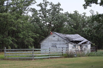 wide-angle abandoned farmhouse collapsing into itself