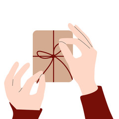 Holiday wrapping. Close up of hands tying a bow on gift with Christmas background. Gift-wrapping services or products