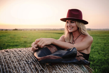 Cheerful Woman in Maroon Hat osing in a Field