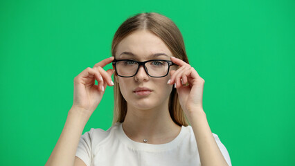 Woman, close-up, on a green background, wearing glasses