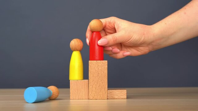 The wooden human figure removes the winner from first place. Business rivalry and rivals. Concept of business success and defeat. Competitions and hierarchy