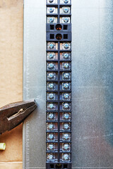 close up photo of contact strip and pliers