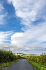 A narrow road in the Dorset countryside, with an interesting sky overhead