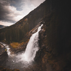 Obraz premium Tourist enjoys the view of the Krimml Waterfalls in High Tauern National Park Austria Alps