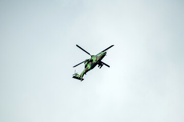 Helicopter is flying on isolated overcast mid-air sky