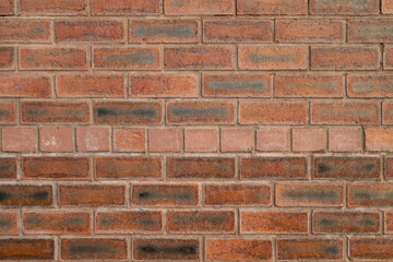 Red brick wall texture background with varying shades arranged in traditional horizontal pattern