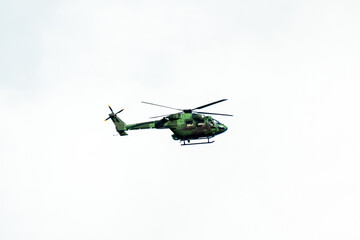 Helicopter is flying on isolated white background