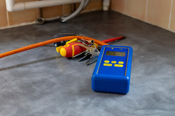 Gas service engineer's digital differential manometer pressure meter on domestic counter top near...