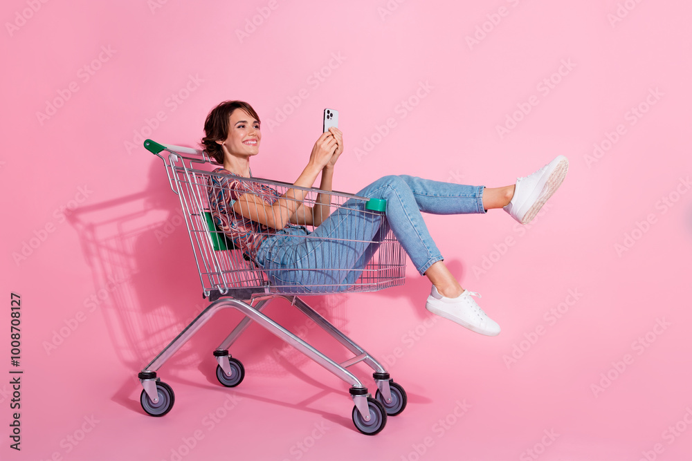 Canvas Prints Photo of positive nice lovely girl wear stylish clothes sitting trolley reading post isolated on pink color background