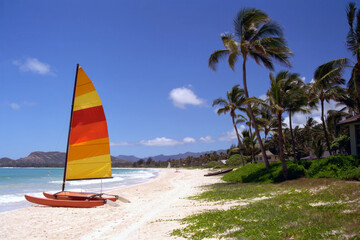 Colourful sailboat on the beautiful long sandy Kailua Beach on the island of Oahu, Hawaii