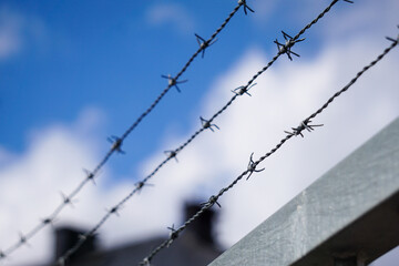 Close-up of barbed wire against the sky