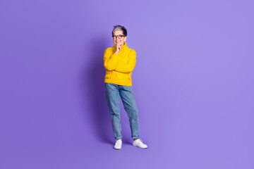 Full length photo of thoughtful positive woman wear yellow sweater smiling empty space isolated violet color background
