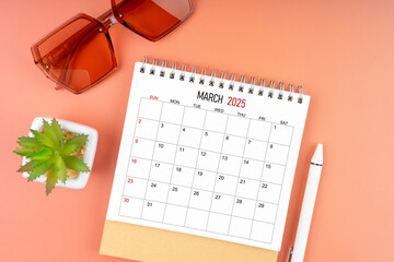 March 2025 desk calendar with brown sunglasses on beautiful background, Appointment concepts.