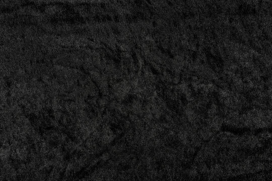 Luxurious black velvet fabric texture with soft, plush pile