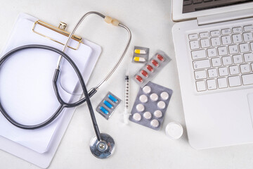 Simple medical healthcare background with notebook, clipboard, stethoscope, syringe and pills, Doctors, tests, health care, annual vaccination background top view copy space