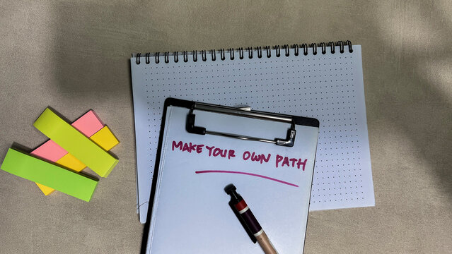 Concept of Make Your Own Path write on paperwork isolated on wooden background.