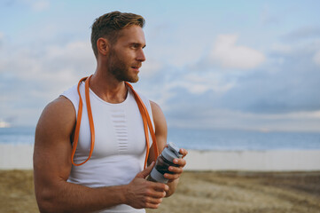 Young strong sporty athletic toned fit sportsman man wears sports clothes elastic rubber band,...