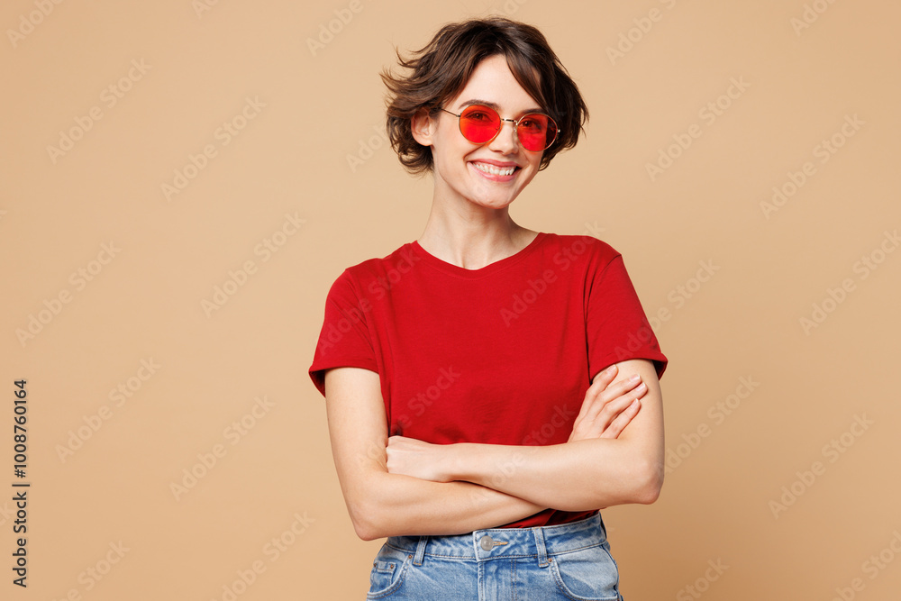 Wall mural young smiling happy fun woman she wear red t-shirt casual clothes sunglasses hold hands crossed fold