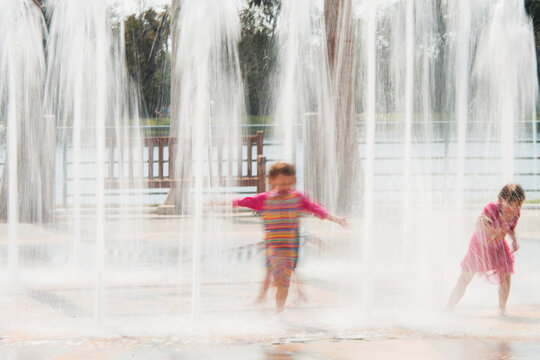 Children playing in the fountain's waters, Celebration County; near Orlando. Florida, USA, 2019