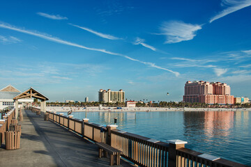 Fototapeta premium Sunny afternoon on Clearwater beach, known for its calm, clear waters, traditional area of sea sports, leisure, fishing and families presence. Clearwater, Florida, USA, 2019