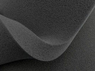 folds of thick black sponge foam. rubber texture sheet with wavy edges