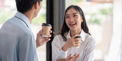 Young Professionals Enjoying Conversational Break Over Coffee. Concept of Workplace Connection and Team Dynamics