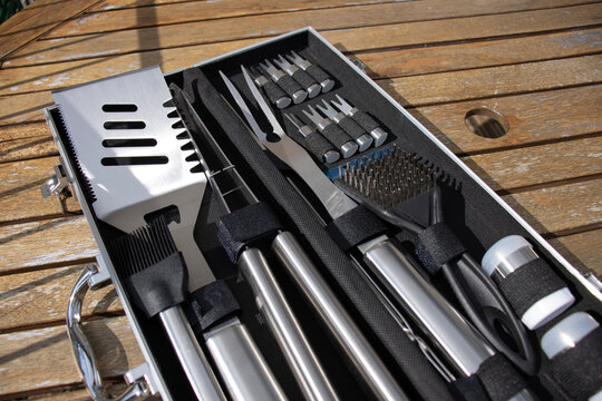 Barbecue tools close up. Set of cooking tools. Metal tongs and spatulas. Homemade food