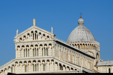 Pisa, Tuscany, Italy. October 03, 2024: Historic Pisa Cathedral fa&ccedil;ade and dome under clear blue sky.