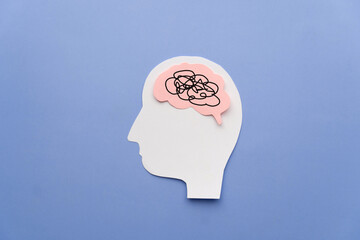 Human head with brain as tangled messy single line on blue background. Concept of mental disorder, ADHD symptom, finding solution, chaotic thinking process, confused mind. Mental health care.