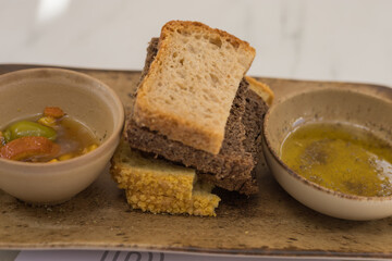 Greek appetizer. Olive oil with olives and homemade baked bread.