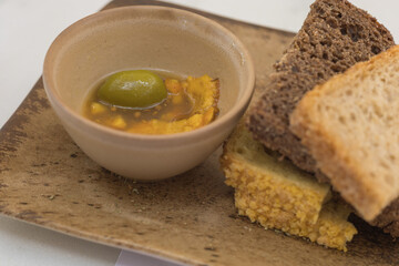 Greek appetizer. Olive oil with olives and homemade baked bread.