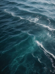 Fototapeta premium The sea’s surface dances with waves, a deep and mysterious blue.